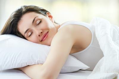 woman sleeping soundly l sleep apnea dentist bloomington in