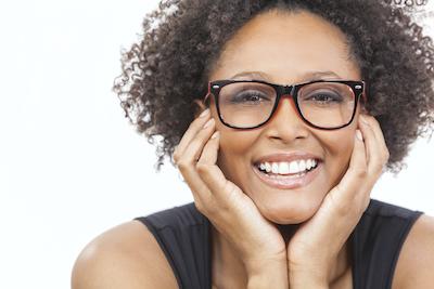 woman with glasses smiling l dentists in bloomington in