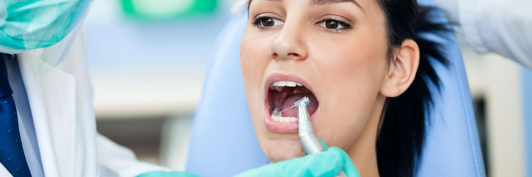 woman receiving dental exam | cosmetic dentist bloomington in