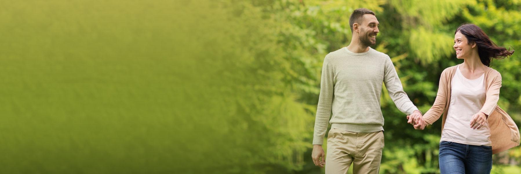young couple walking holding hands l dentist bloomington in