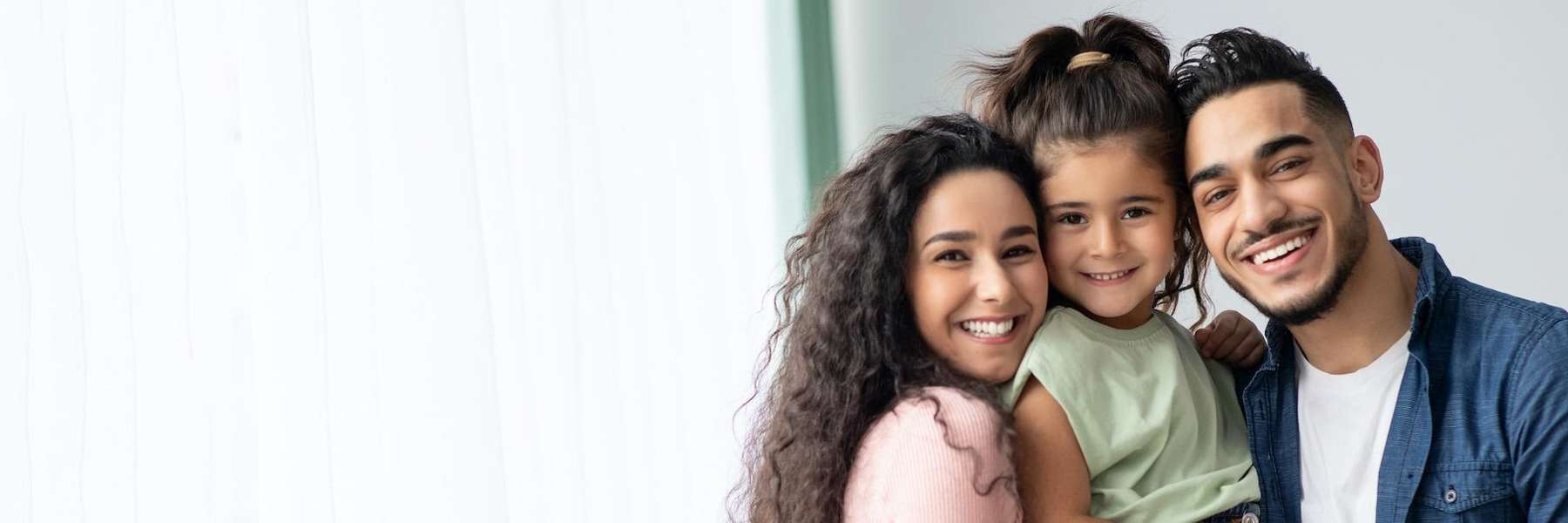 family of three hugging | dentist bloomington indiana