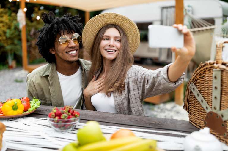 woman and man taking a photo | dental implants bloomington in