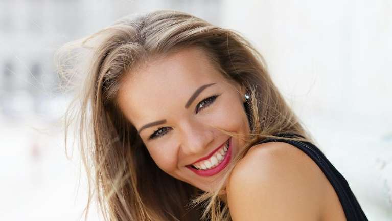 woman with red lipstick smiling | bloomington cosmetic dentist