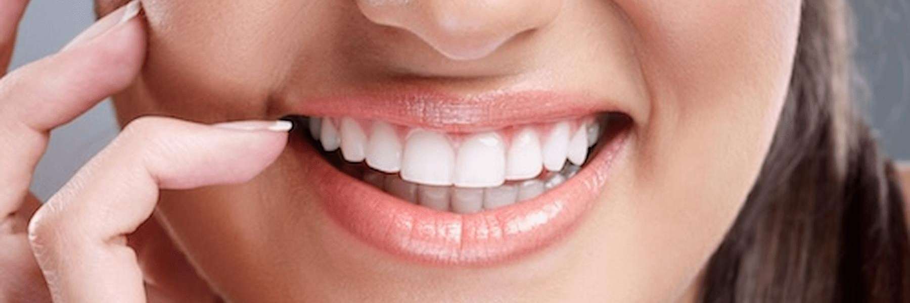 Person smiling brightly, showcasing clean and healthy teeth in Bloomington, IN