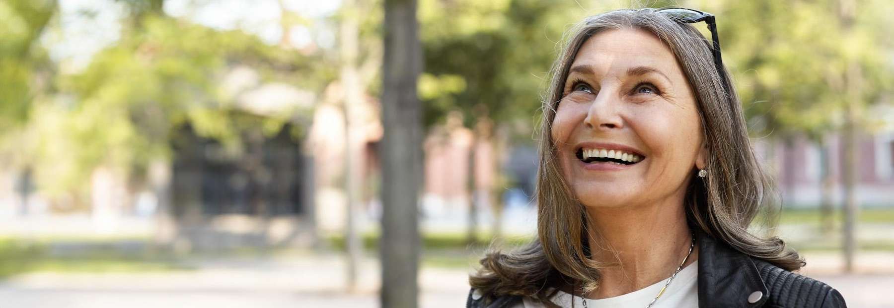 older woman with glasses smiling | dentist bloomington indiana