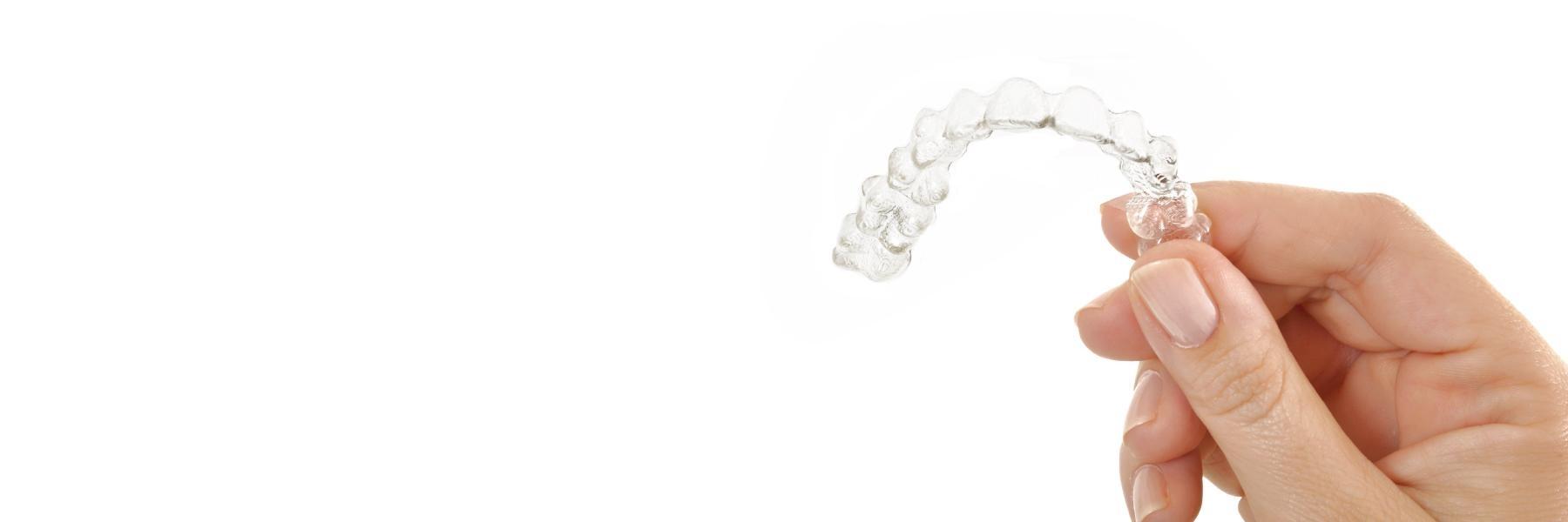 hand holding invisalign tray l Invisalign Bloomington, Indiana