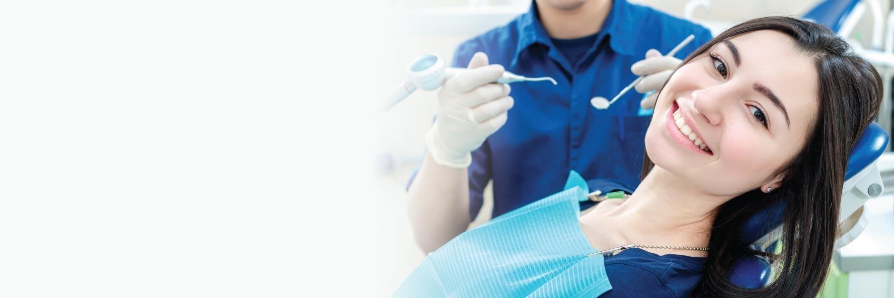 woman in dental exam chair smiling l dentist in bloomington in